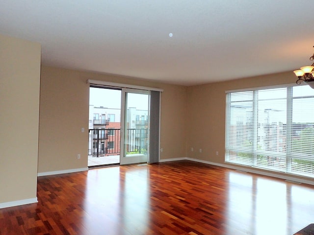 1070 Grandview Ct NE Unit 413, Columbia Heights, MN 55421 - empty room with wood finished floors, a chandelier, and a healthy amount of sunlight