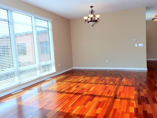1070 Grandview Ct NE Unit 413, Columbia Heights, MN 55421 - unfurnished room with baseboards, a notable chandelier, and wood finished floors