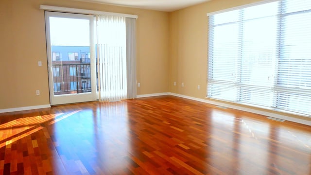 1070 Grandview Ct NE Unit 413, Columbia Heights, MN 55421 - spare room featuring baseboards, a healthy amount of sunlight, and wood finished floors