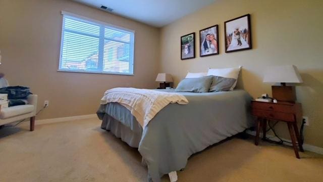 1070 Grandview Ct NE Unit 413, Columbia Heights, MN 55421 - bedroom with baseboards, visible vents, and light carpet