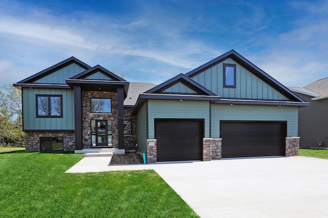 1504 14th Ave NE, Kasson, MN 55944 - view of front of home with stone siding, board and batten siding, a front lawn, driveway, and a garage