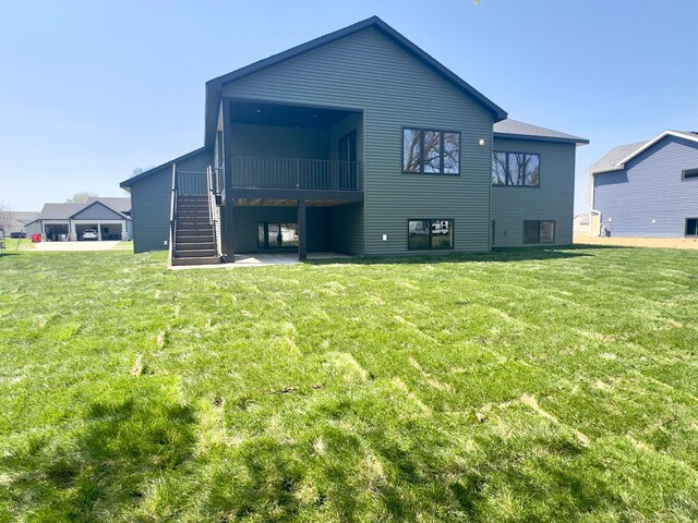 1504 14th Ave NE, Kasson, MN 55944 - rear view of house with stairs, a lawn, and a wooden deck