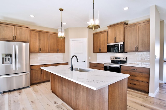 1504 14th Ave NE, Kasson, MN 55944 - kitchen featuring stainless steel appliances, a sink, brown cabinetry, decorative backsplash, and pendant lighting