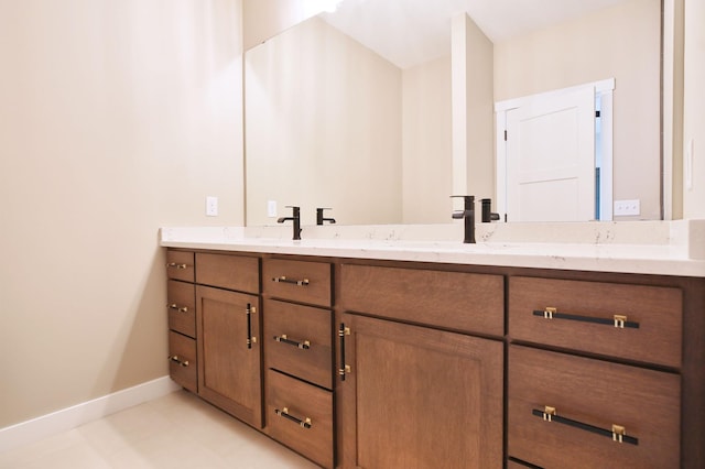 1504 14th Ave NE, Kasson, MN 55944 - bathroom featuring double vanity, baseboards, and tile patterned flooring