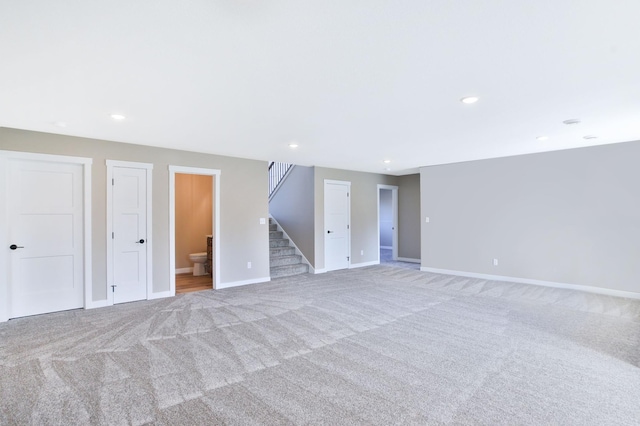 1504 14th Ave NE, Kasson, MN 55944 - carpeted spare room featuring stairs, baseboards, and recessed lighting