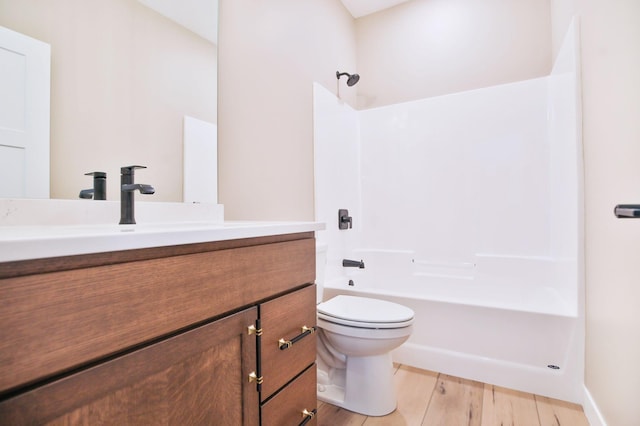1504 14th Ave NE, Kasson, MN 55944 - bathroom featuring toilet, bathing tub / shower combination, vanity, and wood finished floors