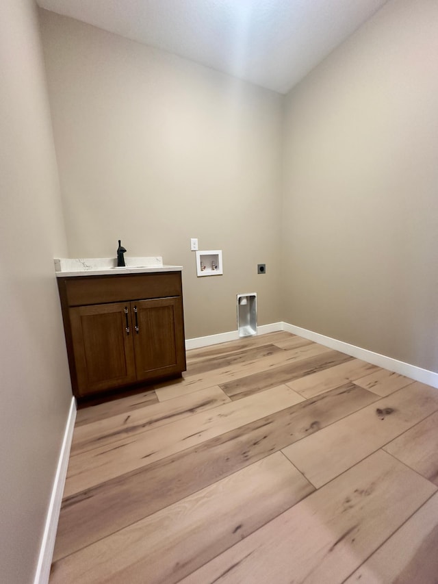 1504 14th Ave NE, Kasson, MN 55944 - laundry area featuring electric dryer hookup, light wood-style floors, washer hookup, and baseboards