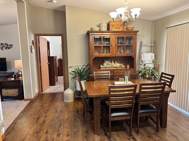 154 Pond Dr, Jackson, MN 56143 - dining room featuring baseboards, a textured ceiling, an inviting chandelier, and dark wood finished floors