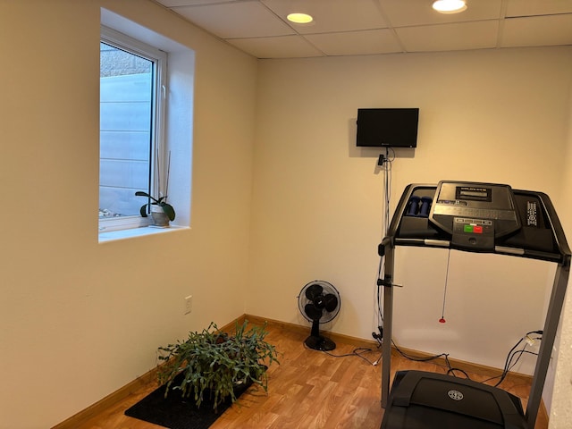 154 Pond Dr, Jackson, MN 56143 - exercise room with baseboards, a paneled ceiling, and wood finished floors