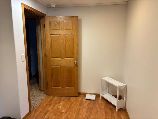 154 Pond Dr, Jackson, MN 56143 - hall featuring a paneled ceiling, light wood-type flooring, and baseboards