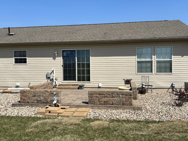 154 Pond Dr, Jackson, MN 56143 - back of property featuring a patio area and roof with shingles