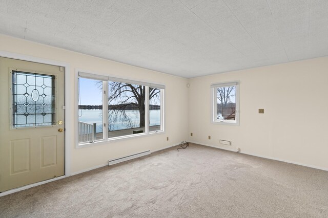 carpeted entryway featuring a baseboard radiator, a water view, and baseboards