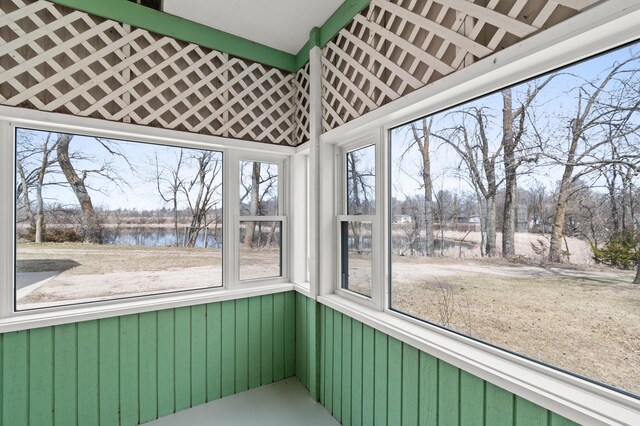unfurnished sunroom with a water view and a healthy amount of sunlight