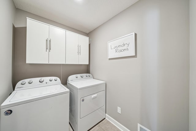 4271 Corn Silk Ln, Woodbury, MN 55129 - laundry area with independent washer and dryer, cabinet space, light tile patterned floors, and baseboards