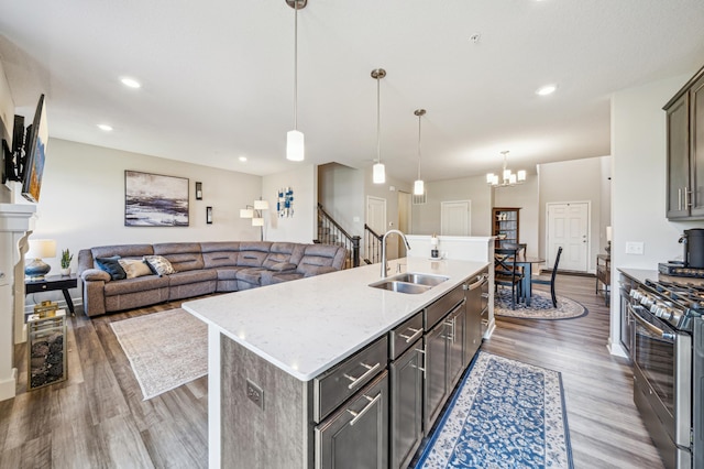 4271 Corn Silk Ln, Woodbury, MN 55129 - kitchen with stainless steel appliances, a sink, wood finished floors, a kitchen island with sink, and recessed lighting