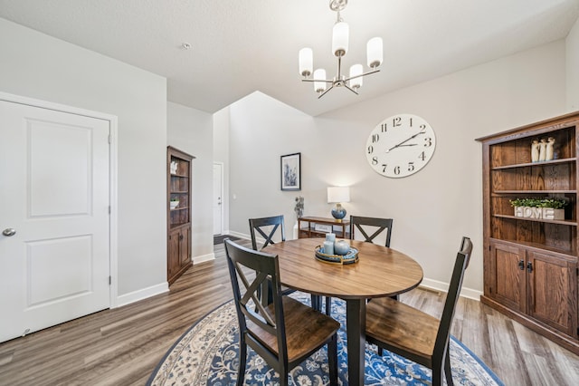 4271 Corn Silk Ln, Woodbury, MN 55129 - dining space featuring a chandelier, wood finished floors, and baseboards