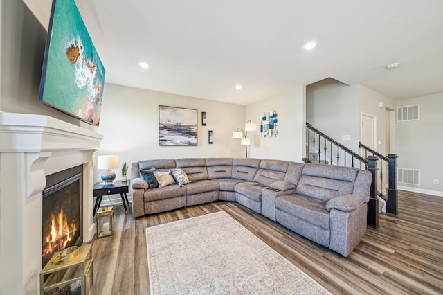 4271 Corn Silk Ln, Woodbury, MN 55129 - living room with wood finished floors, a glass covered fireplace, stairs, baseboards, and recessed lighting