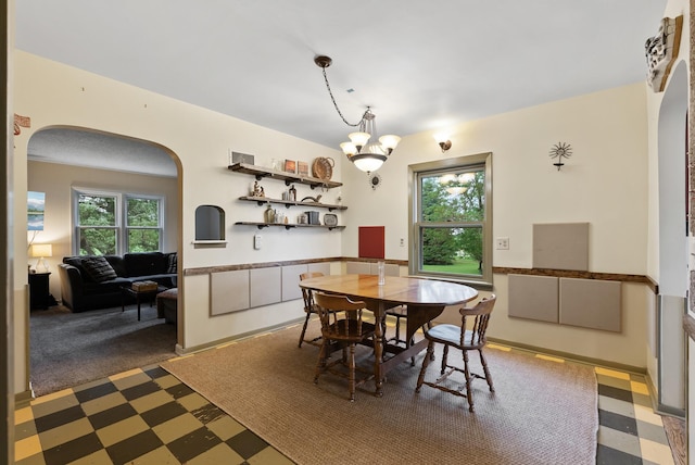 16985 Homestead Rd, Carver, MN 55315 - dining space with arched walkways, tile patterned floors, and a chandelier