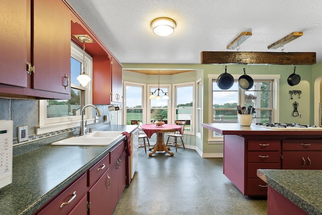 16985 Homestead Rd, Carver, MN 55315 - kitchen with red cabinets, dark countertops, and a textured ceiling