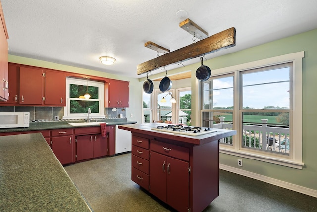 16985 Homestead Rd, Carver, MN 55315 - kitchen with red cabinetry, white appliances, backsplash, a textured ceiling, and healthy amount of natural light