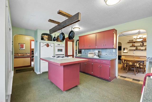 16985 Homestead Rd, Carver, MN 55315 - kitchen with arched walkways, red cabinets, refrigerator, backsplash, and a textured ceiling