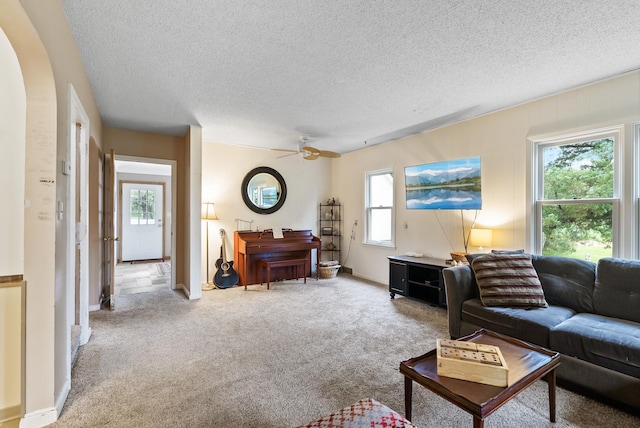 16985 Homestead Rd, Carver, MN 55315 - living room featuring ceiling fan, carpet flooring, a textured ceiling, and arched walkways