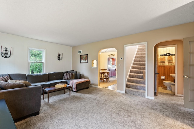 16985 Homestead Rd, Carver, MN 55315 - living area with arched walkways, stairs, and carpet