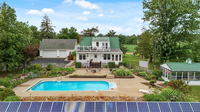 16985 Homestead Rd, Carver, MN 55315 - rear view of property featuring a balcony, a patio, stairs, an outdoor pool, and a metal roof