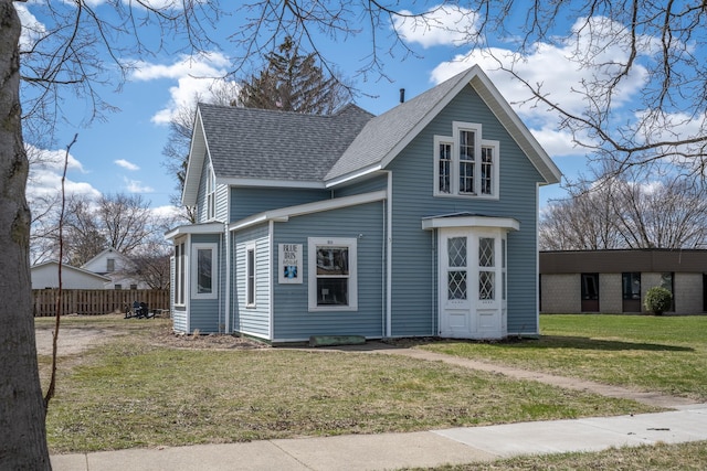 311 Prairie St, Lake City, MN 55041 - exterior space featuring fence, a shingled roof, and a front lawn