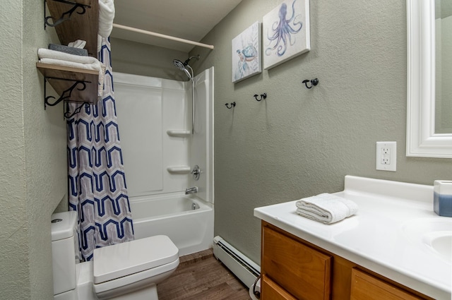 311 Prairie St, Lake City, MN 55041 - bathroom with a baseboard heating unit, toilet, wood finished floors, a textured wall, and vanity