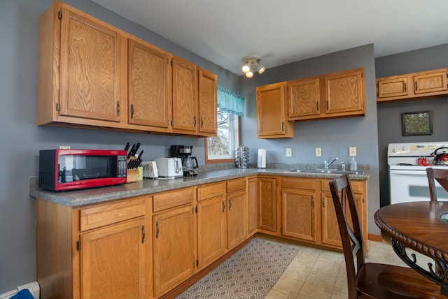311 Prairie St, Lake City, MN 55041 - kitchen featuring a baseboard radiator, white electric stove, brown cabinetry, and a sink