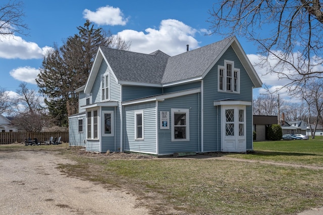 311 Prairie St, Lake City, MN 55041 - view of property exterior with fence, a lawn, and roof with shingles