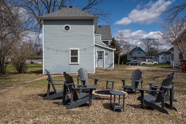 311 Prairie St, Lake City, MN 55041 - rear view of house with a fire pit, roof with shingles, and a lawn