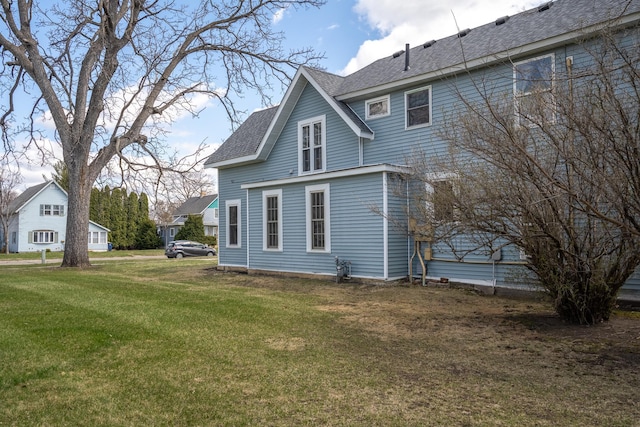311 Prairie St, Lake City, MN 55041 - back of house featuring a lawn and roof with shingles