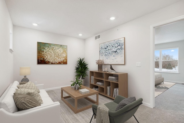 living room featuring baseboards, light carpet, visible vents, and recessed lighting