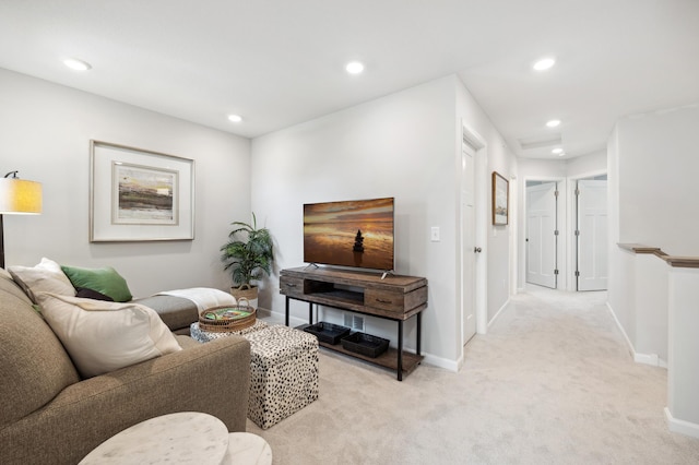 living room with recessed lighting, baseboards, and light colored carpet