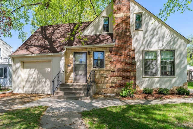 view of front of property featuring an attached garage, stucco siding, a chimney, and driveway