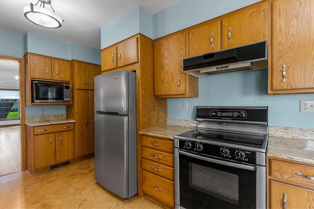 kitchen featuring appliances with stainless steel finishes, under cabinet range hood, and brown cabinetry