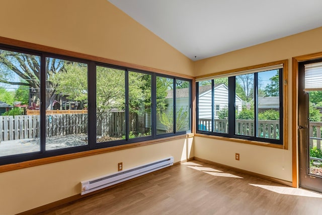 unfurnished sunroom with baseboard heating, lofted ceiling, wood finished floors, and baseboards