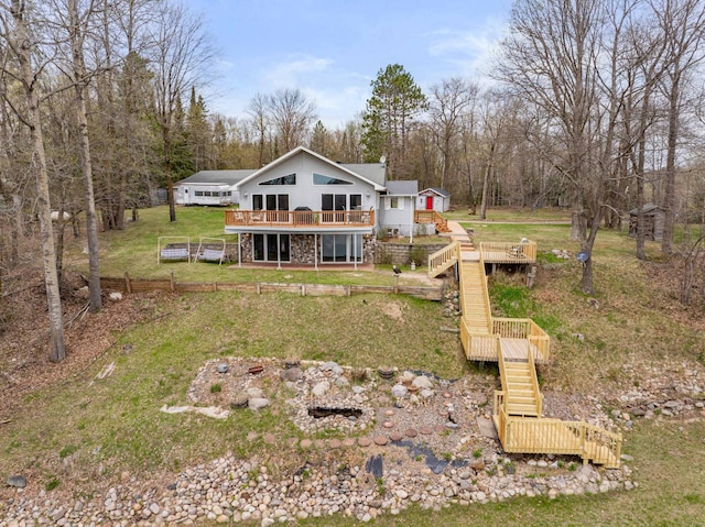 16227 Bay Dr, Pengilly, MN 55775 - rear view of property featuring stairway, a wooden deck, a yard, and a view of trees