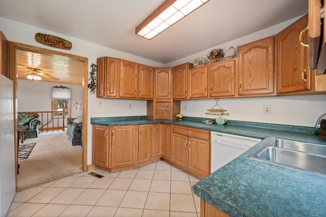 16227 Bay Dr, Pengilly, MN 55775 - kitchen featuring white appliances, a sink, light tile patterned floors, and dark countertops