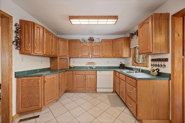 16227 Bay Dr, Pengilly, MN 55775 - kitchen with white dishwasher, a sink, dark countertops, light tile patterned floors, and brown cabinetry