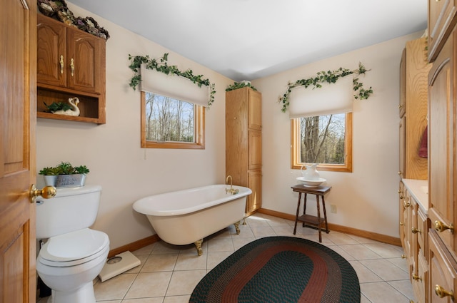 16227 Bay Dr, Pengilly, MN 55775 - bathroom featuring healthy amount of natural light, toilet, baseboards, and a soaking tub