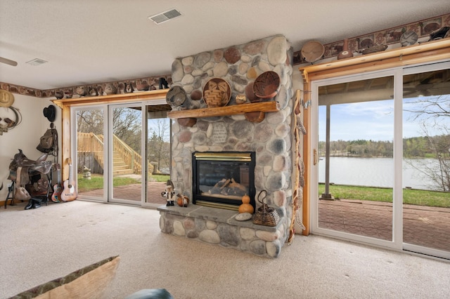 16227 Bay Dr, Pengilly, MN 55775 - unfurnished living room with carpet floors, a water view, and a fireplace