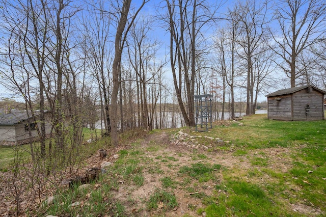 16227 Bay Dr, Pengilly, MN 55775 - view of grassy yard with an outbuilding and a water view