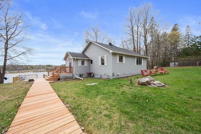16227 Bay Dr, Pengilly, MN 55775 - rear view of house with a deck with water view and a lawn