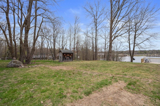 16227 Bay Dr, Pengilly, MN 55775 - view of grassy yard featuring a storage shed, a water view, and an outbuilding