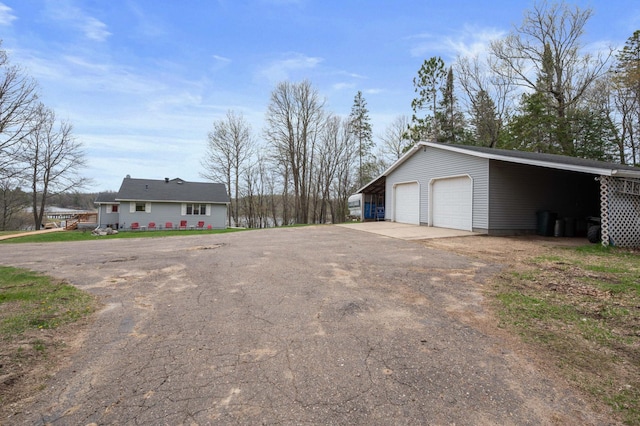 16227 Bay Dr, Pengilly, MN 55775 - view of side of property with an outbuilding, a garage, and driveway