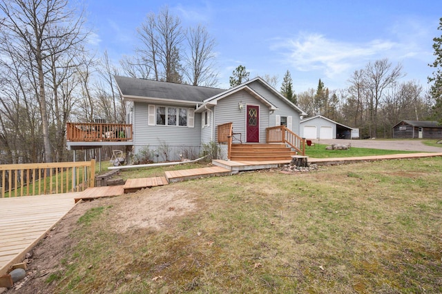 16227 Bay Dr, Pengilly, MN 55775 - view of front of property with a deck, a front lawn, a garage, and an outbuilding