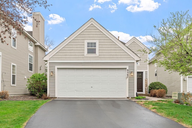 traditional home with driveway and a front lawn